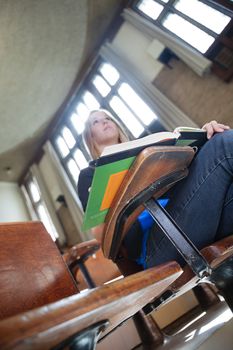 Low angle view of young college girl paying attention in lecture