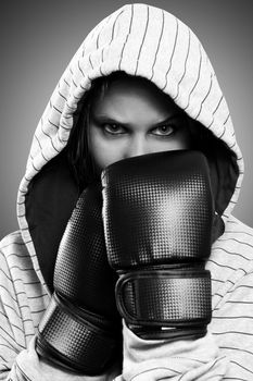 Black and white portrait of a woman with boxing gloves