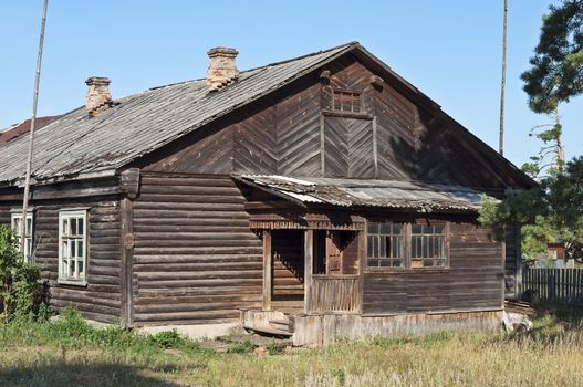 Old wooden barrack in russian village, sunny summer day