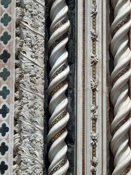 Detail of ornate stone sculptured pattern around central doorway of Orvieto Duomo