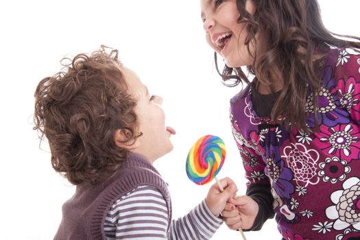 kids licking a lollipop on a white background