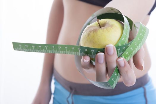 green apple and measuring tape isolated on a white