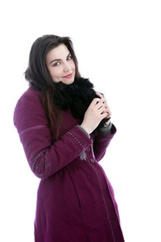 Woman dressed up warmly against the winter cold with a thick coat and warm woolly scarf isolated on white