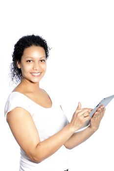 Beautiful young African American woman scrolling on her tablet using her finger on the touchscreen as she accesses the internet isolated on white