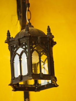 Antique bronze lantern on yellow background