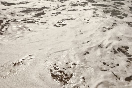 Closeup of beautiful white sea foam and waves