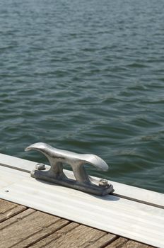 Detail of a wooden floating dock with mooring bitts