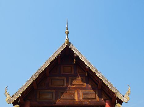 Traditional wooden gable of Buddhist vihara having bee hive on top in Mae hong Son, Thailand