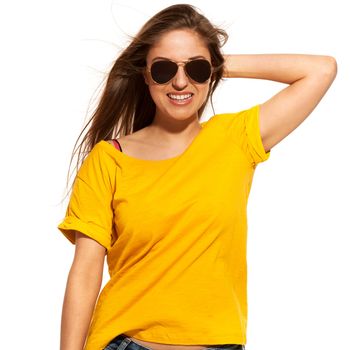 Positive young woman in yellow shirt with sunglasses over white background