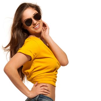 Positive young woman in yellow shirt with sunglasses over white background