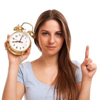 Young caucasian woman with alarm clock in her hands