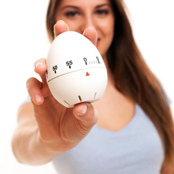 Young caucasian woman with kitchen timer in her hands