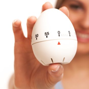 Young caucasian woman with kitchen timer in her hands