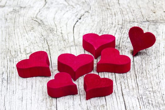 red hearts on wooden background