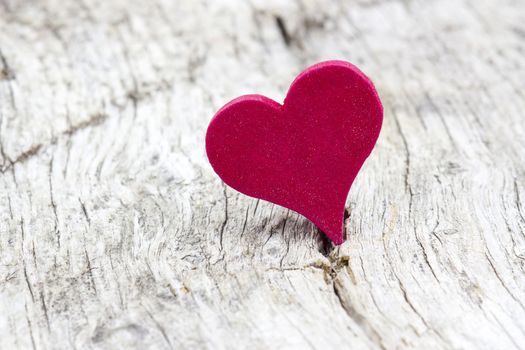 red heart on wooden background