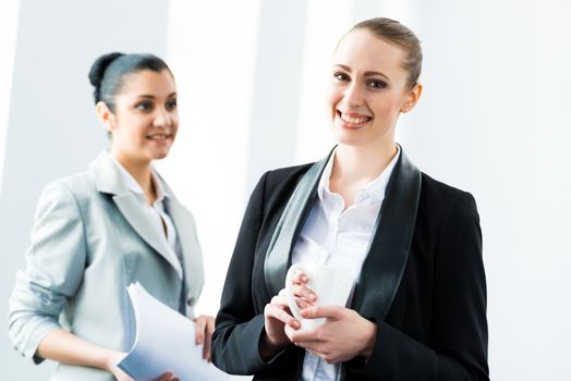 two business women discussing documents in the office