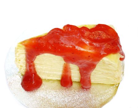 Crape cake with strawberry sauce on white background