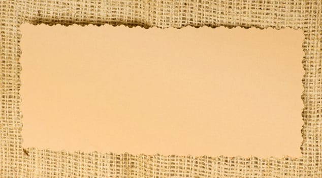 Old paper tag on natural burlap