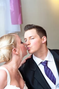 Handsome groom kissing her bride