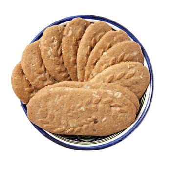 Cereal cookies in a bowl isolated over white
