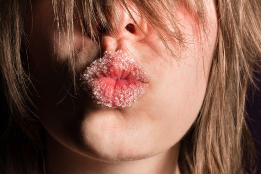 Beautiful young girl kissing with sugar on her mouth