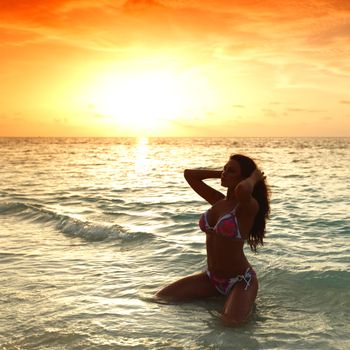 Beautiful sexy woman in bikini posing on beach