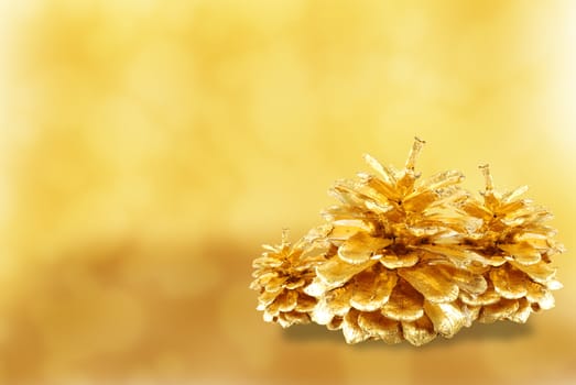 Golden pine cone isolated on white