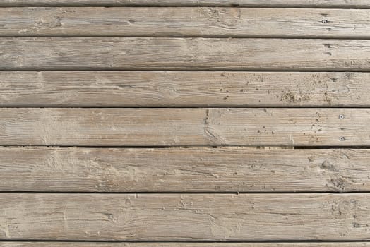 Aged beach brown wooden floor over summer sand