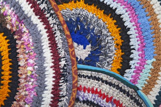 Handmade rugs crocheted of colorful fabric ribbons