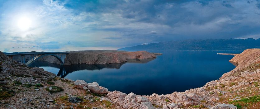 Panoramic HDR photo of the bridge to the Pag island in Croatia. Velebit mountain in the background.