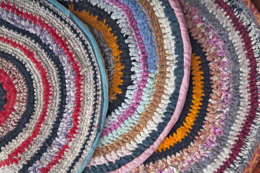 Handmade rugs crocheted of colorful fabric ribbons
