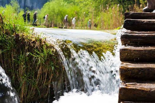 Wet wooden stairs with water and people in the background