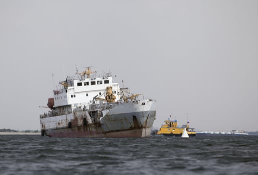 Abandoned ship in the middle of a river