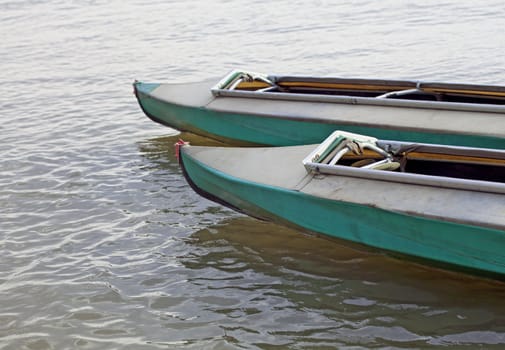 Two canoes on still water of a lake