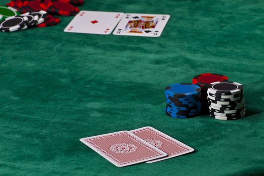 Cards and chips in a Texas hold 'em poker game.