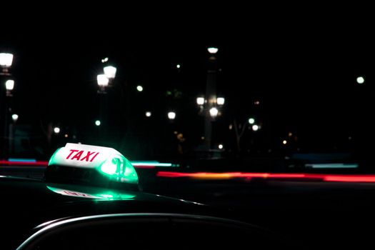 At night it is always safer to get a taxi. Night shot of taxi sign, taken at Place Concorde, Paris.