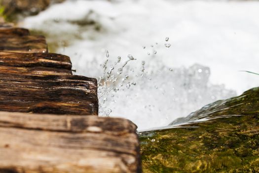 Wet wooden stairs with whitewater splash