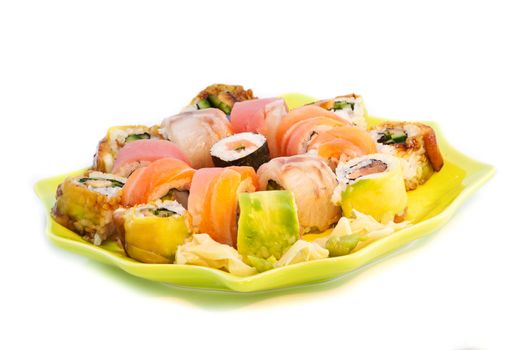 Colorful sushi set in a green plate, isolated on white