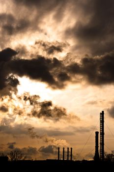 Silhouette of a power plant against evening sky