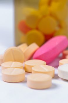 Pills laying very peacefully on white isolated background