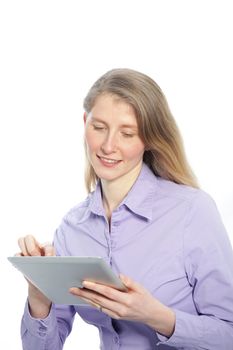 Attractive slim middle-aged woman with long blond hair standing using a tablet computer isolated on white