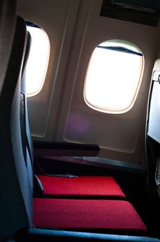 Seat of an airplane with windows in the background