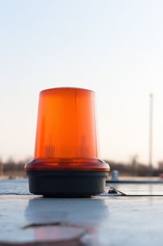 An orange siren on a top of a car