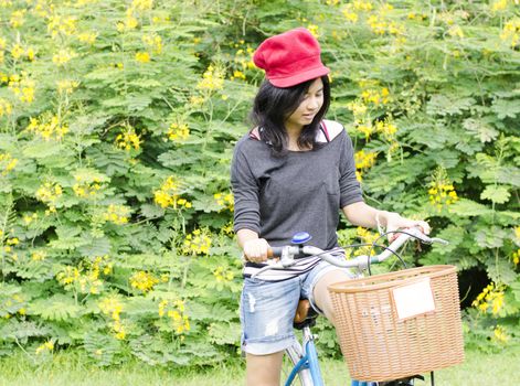 Hispanic woman in park with bike