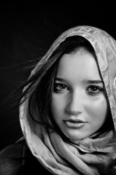 Closeup of a beautiful girl in scarf in black and white