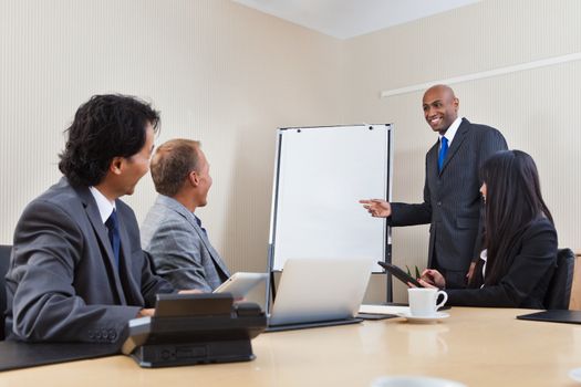 An African American business man giving a presentation to associates