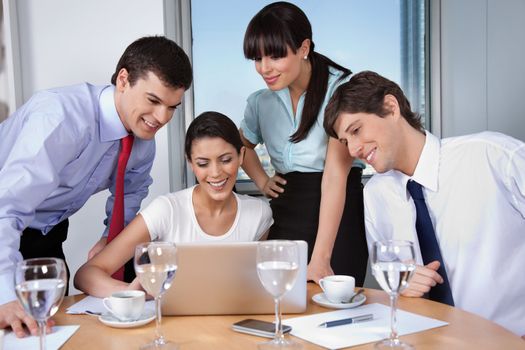 Business woman with her team working on laptop