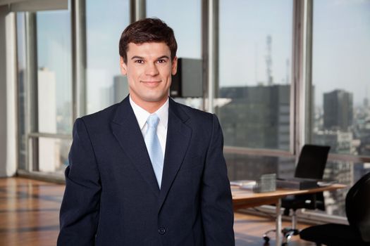 Portrait of smart well-dressed male entrepreneur smiling