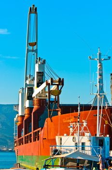 Big transportation boat at the bay against blue sky