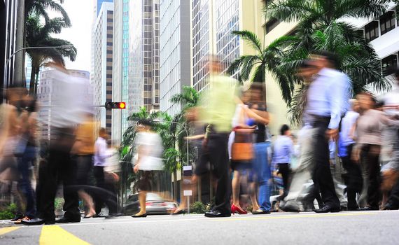 Unidentified businessmen crossing the street in Singapore. There are more than 7,000 multinational corporations from US States, Japan and Europe in Singapore